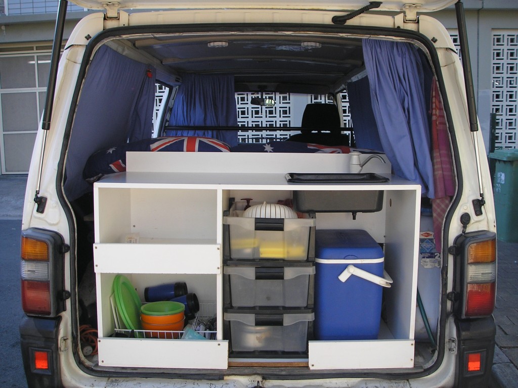 Back of a campervan packed with essential items. 