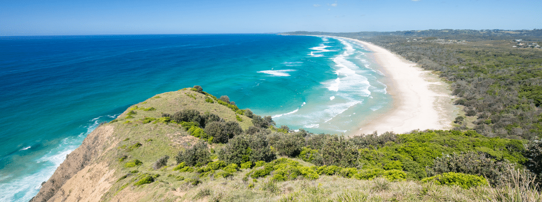 A famous view from Lighthouse Rd over Tallows Beach and Cape Byron in Byron Bay, New South Wales, Australia