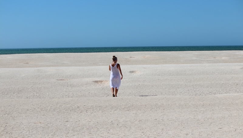 Girl walking in the sand