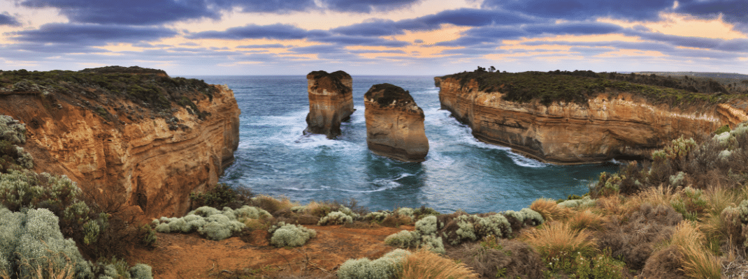 Great ocean road landmarks in VIctoria, Australia. Panoramic view on 2 disconnected rocks in a bay from Loch Ard Gorge lookout in Port Campbell national park