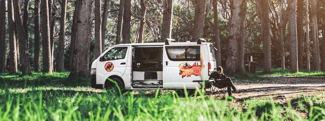 Campervan parked under green trees in Australia