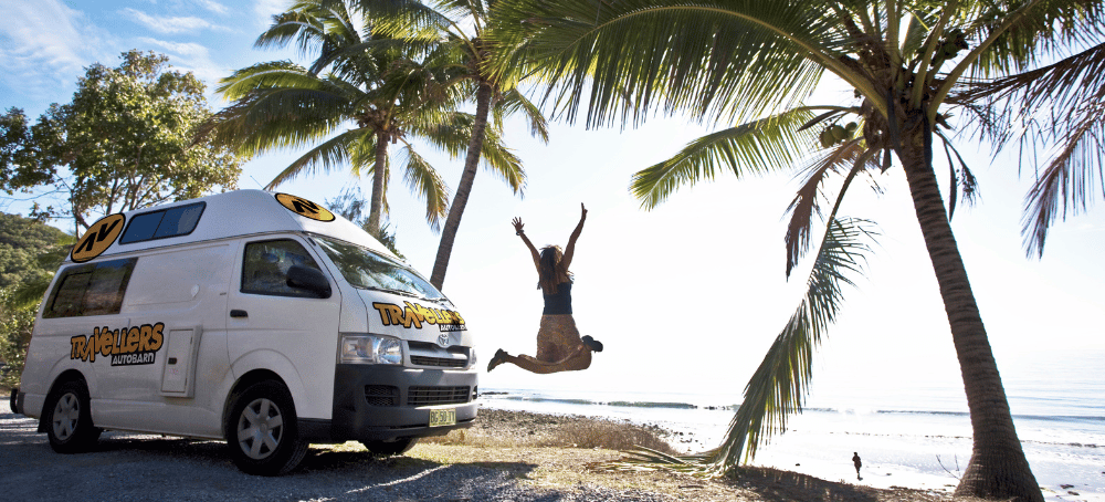 Person jumping next to campervan