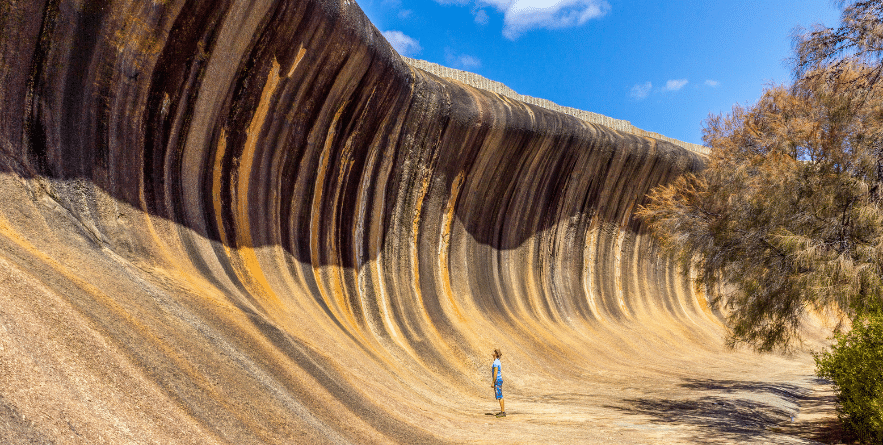 young caucasian man standing at Wave Rock. Wave Rock, Hyden, Western Australia