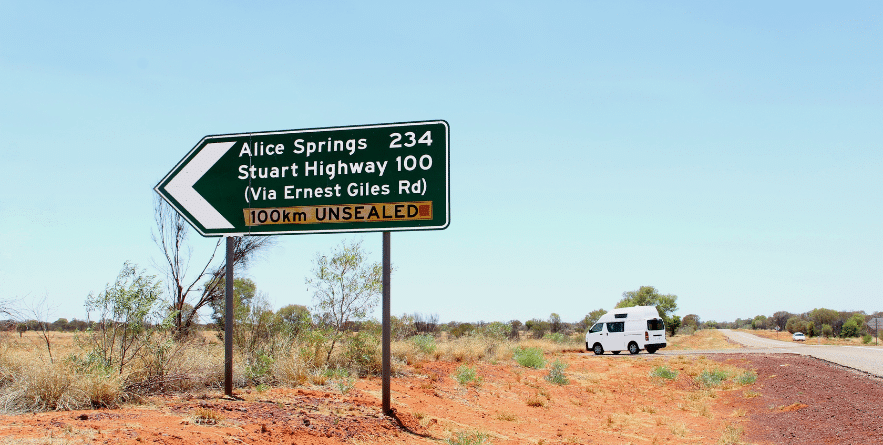 Campervan on road heading towards Stuart Highway, Northern Territory, Australia