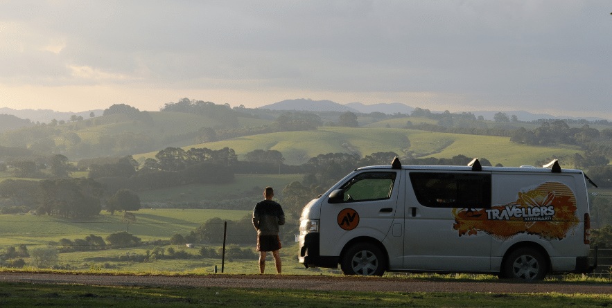 Campervan on road with view of rolling hills in Australia